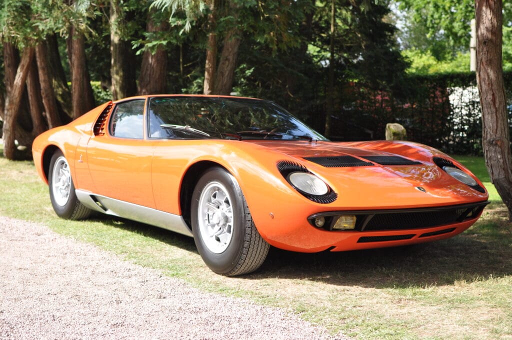 Orange colored Lamborghini Miura from front left.