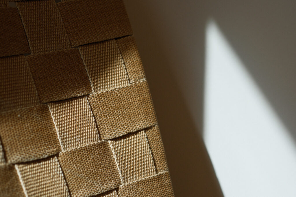 Bruno Mathsson woven chair with curved wood frame and webbed seat in close up