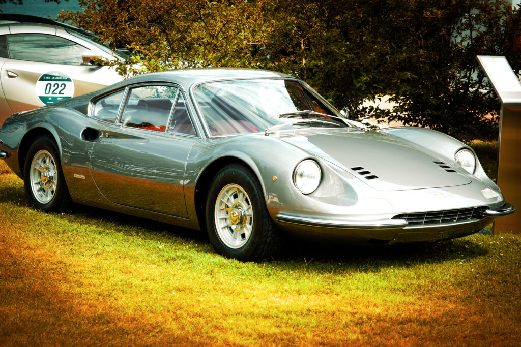 Front wheel and bodywork of a silver Ferrari Dino.
